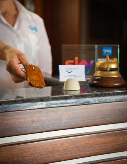 Reception with key, bell, and business card.