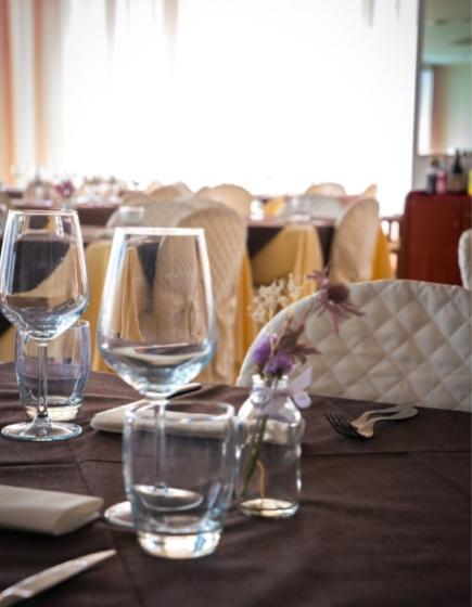 Elegant table set with glasses and flowers in a restaurant.