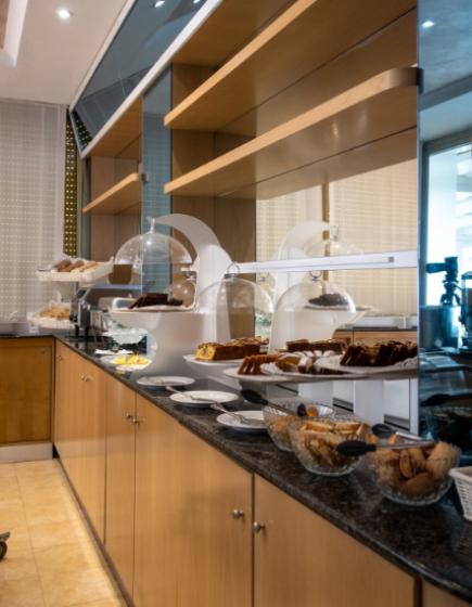 Buffet with assorted desserts on a wooden counter.