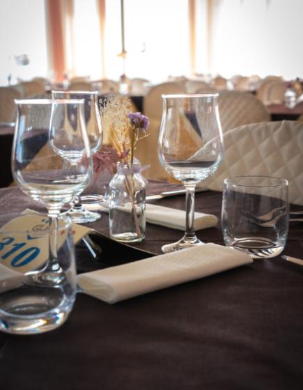 Elegant table with glasses and dried flowers.